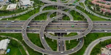 Modern highway interchange with multiple lanes and bridges, symbolizing infrastructure investment